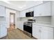 Modern kitchen with white cabinets, stainless steel appliances, and quartz countertops at 1437 Abberton Dr, Orlando, FL 32837