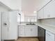 Bright kitchen featuring white cabinetry, stainless steel appliances, and granite countertops at 1437 Abberton Dr, Orlando, FL 32837