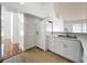 Well-lit kitchen with white appliances, cabinets, and countertops on wood-look flooring at 1437 Abberton Dr, Orlando, FL 32837