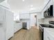 Bright kitchen with white cabinets, modern appliances, and quartz countertops at 1437 Abberton Dr, Orlando, FL 32837