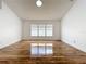 Spacious living room featuring hardwood floors, a large window, and neutral paint at 1437 Abberton Dr, Orlando, FL 32837