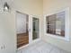 Enclosed porch featuring neutral paint, tile floor, and sliding glass door at 1437 Abberton Dr, Orlando, FL 32837