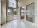 Enclosed porch with tile flooring, multiple windows and sliding glass door at 1437 Abberton Dr, Orlando, FL 32837