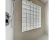 Closeup of a shower stall featuring tiled walls, a glass block window, and a modern shower head at 1437 Abberton Dr, Orlando, FL 32837