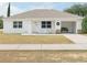 Charming single-story home featuring a covered porch and well-maintained front yard at 860 S Grove St, Eustis, FL 32726