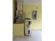 Utility closet showcasing the water heater and AC system with basic fittings at 860 S Grove St, Eustis, FL 32726