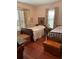 Shared bedroom with twin beds, wood floors, and bright natural lighting at 535 S Jackson Ave, Bartow, FL 33830