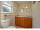 Bathroom with wood cabinets and granite countertop at 815 E Church St, Bartow, FL 33830