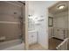 Clean bathroom with shower/tub combo, vanity, and linen shelves at 815 E Church St, Bartow, FL 33830