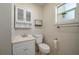 Small bathroom with white vanity, toilet, and medicine cabinet at 815 E Church St, Bartow, FL 33830