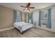 Bright bedroom with double bed, ceiling fan, and light wood flooring at 815 E Church St, Bartow, FL 33830