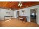 Living room with wood floors, piano, and wood ceiling at 815 E Church St, Bartow, FL 33830