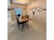 Dining area with a wood table, black chairs, and Gathering photo wall art at 1083 Sunshine Sw Way, Winter Haven, FL 33880