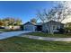 Gray house with a two-car garage and well-maintained lawn at 1083 Sunshine Sw Way, Winter Haven, FL 33880