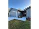 Front view of a gray house with a two-car garage at 1083 Sunshine Sw Way, Winter Haven, FL 33880