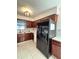 Kitchen features dark wood cabinets and black appliances at 1083 Sunshine Sw Way, Winter Haven, FL 33880