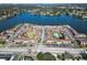 Aerial view of lakefront apartment community with tennis courts and ample parking at 1920 E Edgewood Dr # A4, Lakeland, FL 33803