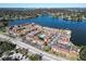 Aerial view of apartment complex by the lake, featuring tennis courts at 1920 E Edgewood Dr # A4, Lakeland, FL 33803