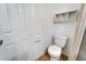 Simple bathroom with toilet and wall shelving at 1920 E Edgewood Dr # A4, Lakeland, FL 33803