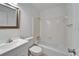 Clean bathroom with white tiled walls, bathtub, and vanity at 1920 E Edgewood Dr # A4, Lakeland, FL 33803