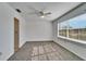 Sunny bedroom, featuring two windows with blinds and ceiling fan at 1920 E Edgewood Dr # A4, Lakeland, FL 33803