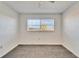 Bright bedroom featuring a large window with blinds and grey carpet at 1920 E Edgewood Dr # A4, Lakeland, FL 33803