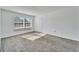 Living room with a large window and grey carpet at 1920 E Edgewood Dr # A4, Lakeland, FL 33803