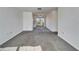 Spacious living room with grey carpet and access to other rooms at 1920 E Edgewood Dr # A4, Lakeland, FL 33803