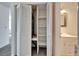 White closet with built-in shelving and stacked washer/dryer at 1920 E Edgewood Dr # A4, Lakeland, FL 33803