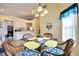 Dining area with glass table, wicker chairs, and kitchen view at 2178 Sunstone Dr, Lakeland, FL 33813