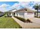 Single-story house with attached garage, landscaping, and walkway at 2178 Sunstone Dr, Lakeland, FL 33813