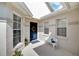 Front entry with blue door, white bench, and potted plants at 2178 Sunstone Dr, Lakeland, FL 33813