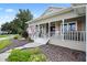 Inviting front porch with rocking chairs and white columns at 2375 Miles Ct, Lakeland, FL 33812