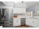 Kitchen with white cabinets and stainless steel fridge at 2375 Miles Ct, Lakeland, FL 33812