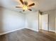 Light and airy bedroom featuring a ceiling fan and wood-look floors at 4201 Shadow Wood Dr, Winter Haven, FL 33880