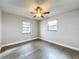 Bright bedroom with wood-look floors and ceiling fan at 4201 Shadow Wood Dr, Winter Haven, FL 33880