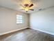 Charming bedroom with a window, ceiling fan, and wood-look floors at 4201 Shadow Wood Dr, Winter Haven, FL 33880