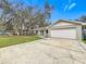 Single-story house with a large yard and a driveway at 4201 Shadow Wood Dr, Winter Haven, FL 33880