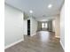 Bright hallway with wood-look floors and access to closet and rooms at 4201 Shadow Wood Dr, Winter Haven, FL 33880