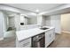 Modern kitchen with island, white cabinets, and quartz countertops at 4201 Shadow Wood Dr, Winter Haven, FL 33880