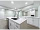 Modern kitchen island with white cabinets and quartz countertops at 4201 Shadow Wood Dr, Winter Haven, FL 33880