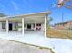 Covered patio, basketball hoop and grassy backyard at 503 Se 3Rd St, Mulberry, FL 33860