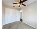 Well-lit bedroom featuring ceiling fan and double-door closet at 503 Se 3Rd St, Mulberry, FL 33860