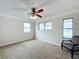 Bright bedroom with ceiling fan, carpet, and ample natural light at 503 Se 3Rd St, Mulberry, FL 33860