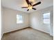 Bedroom with ceiling fan and two windows at 503 Se 3Rd St, Mulberry, FL 33860