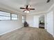 Spacious bedroom with ceiling fan and access to another room at 503 Se 3Rd St, Mulberry, FL 33860