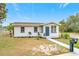 Newly renovated single story home with a walkway and mailbox at 503 Se 3Rd St, Mulberry, FL 33860