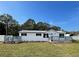 Newly remodeled single-wide home with gray deck and fenced yard at 7612 Glen Meadow Dr, Lakeland, FL 33810