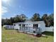 Newly remodeled single-wide home with gray deck and fenced yard at 7612 Glen Meadow Dr, Lakeland, FL 33810