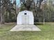 White storage shed with covered carport at 7612 Glen Meadow Dr, Lakeland, FL 33810